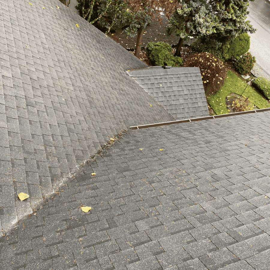 Asphalt roof valley after loose leaves and organic debris were cleared