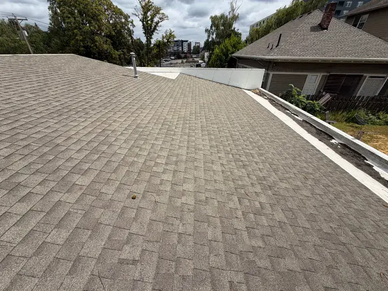 Low-slope shingle roof on the same Portland job after moss removal